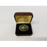 AN OPAL BROOCH, THE OVAL STONE IN A 9CT GOLD SETTING.