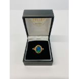 AN OPAL RING, THE OVAL STONE IN A TWISTED SETTING ON A 9CT GOLD BAND.