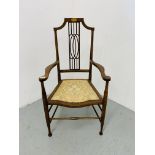 AN EDWARDIAN MAHOGANY STRUNG BACK ELBOW CHAIR WITH UPHOLSTERED SEAT