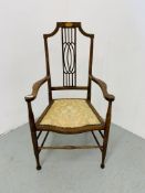 AN EDWARDIAN MAHOGANY STRUNG BACK ELBOW CHAIR WITH UPHOLSTERED SEAT