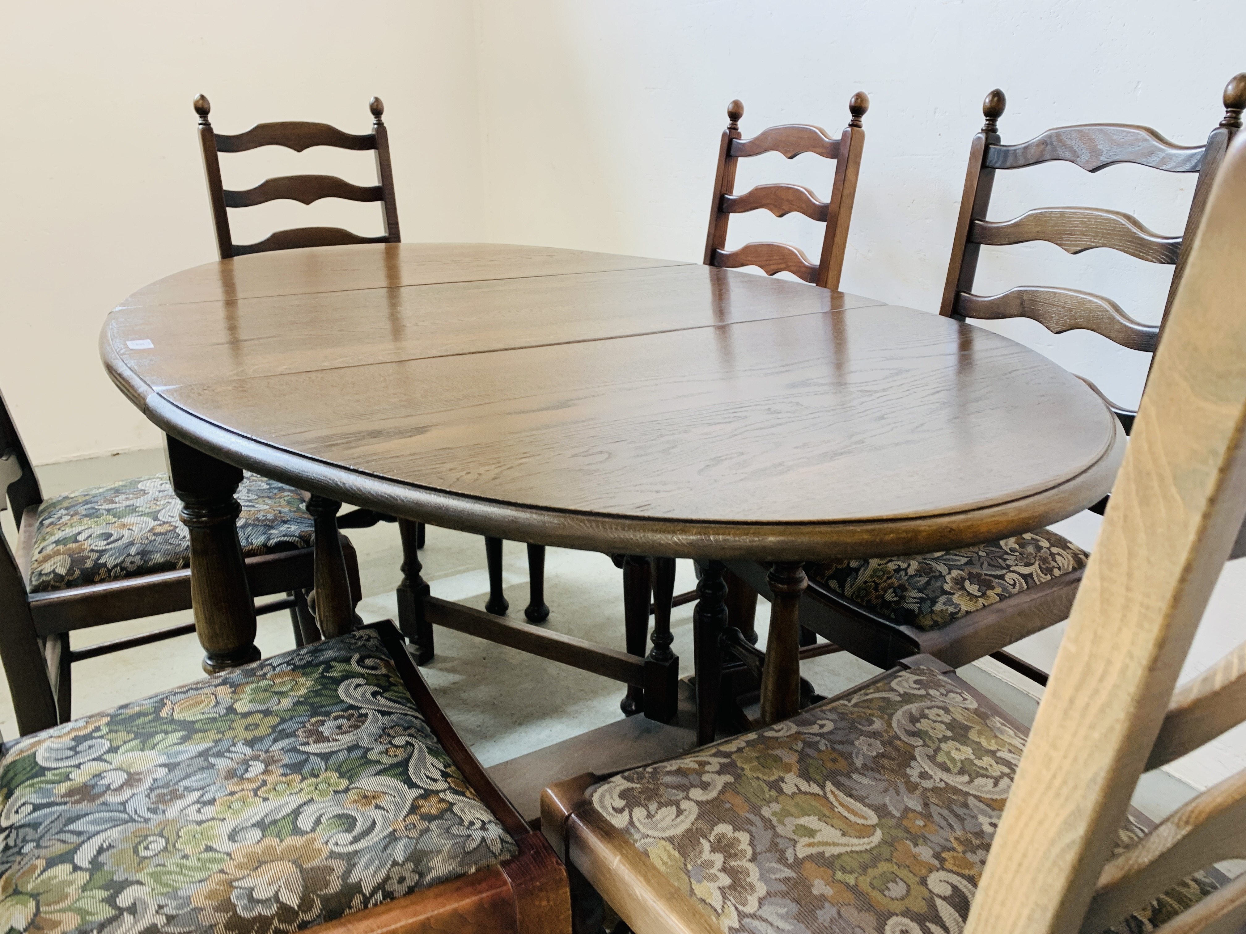 AN OVAL TOP OAK GATELEG DINING TABLE EXTENDED 152 X 91CM ALONG WITH A SET OF SIX LADDER BACK DINING - Image 5 of 12