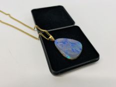 AN OPAL FRENCH PENDANT OF TRIANGULAR FORM IN AN UNMARKED YELLOW SETTING ALONG WITH A 9CT GOLD CHAIN
