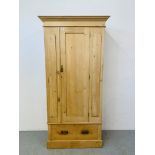 AN ANTIQUE STRIPPED AND WAXED PINE WARDROBE WITH DRAWER TO BASE - W 95CM. H 196CM. D 41CM.