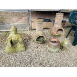 A LARGE STONEWORK ORIENTAL GARDEN DEITY ALONG WITH TWO TERRACOTTA CHIMINEAS,