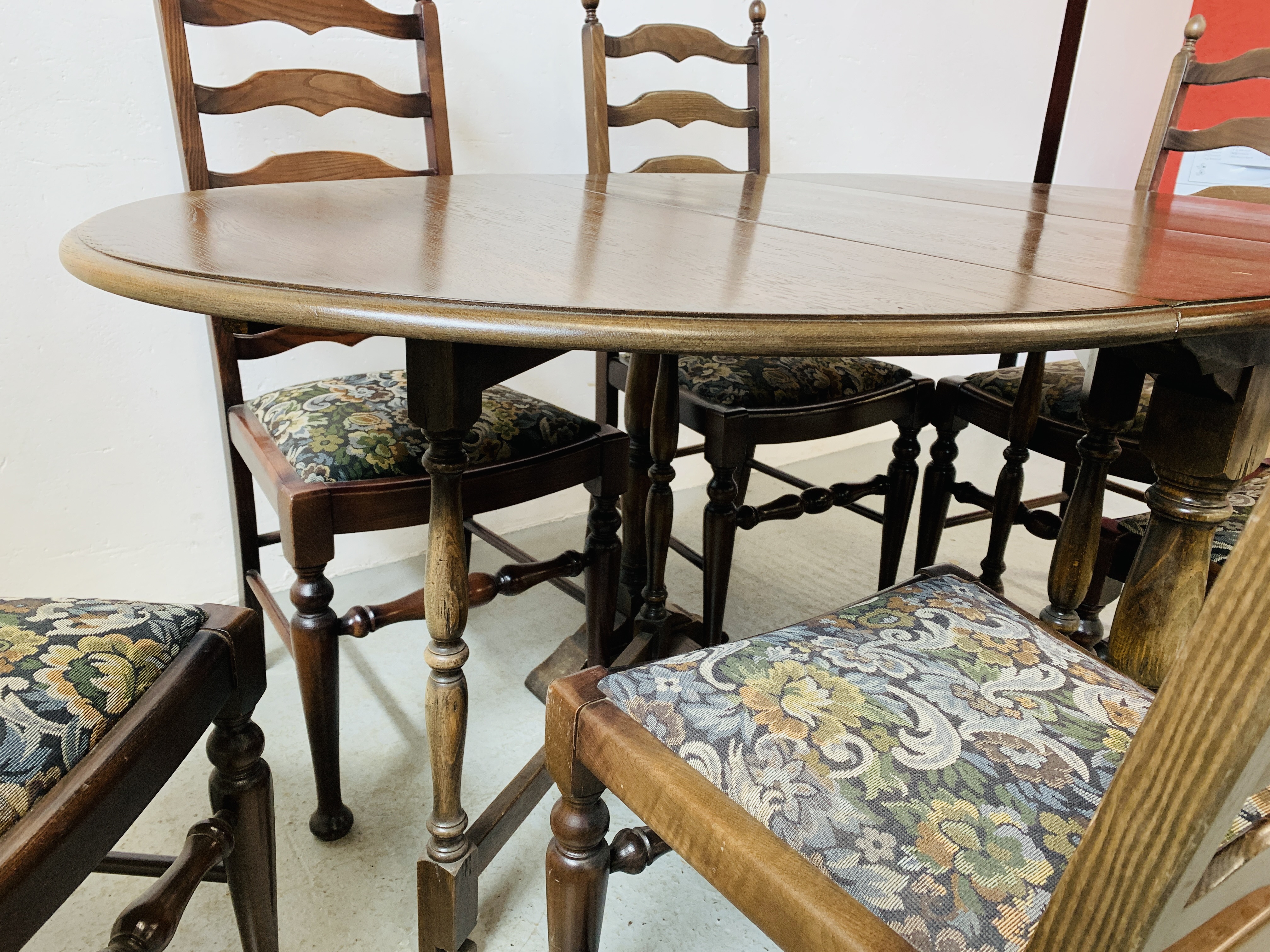 AN OVAL TOP OAK GATELEG DINING TABLE EXTENDED 152 X 91CM ALONG WITH A SET OF SIX LADDER BACK DINING - Image 8 of 12