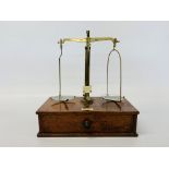 A BRASS BALANCE BY MAW & SONS, ALDERSGATE STREET, LONDON ON MAHOGANY BASE, WIDTH 28.