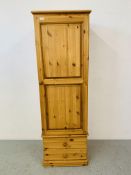 A HONEY PINE SINGLE DOOR WARDROBE / COAT CUPBOARD WITH TWO DRAWERS TO BASE - W 57CM. H 185CM.
