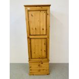 A HONEY PINE SINGLE DOOR WARDROBE / COAT CUPBOARD WITH TWO DRAWERS TO BASE - W 57CM. H 185CM.