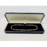 A SINGLE STRAND FRESHWATER PEARL NECKLACE WITH 9CT GOLD CLASP