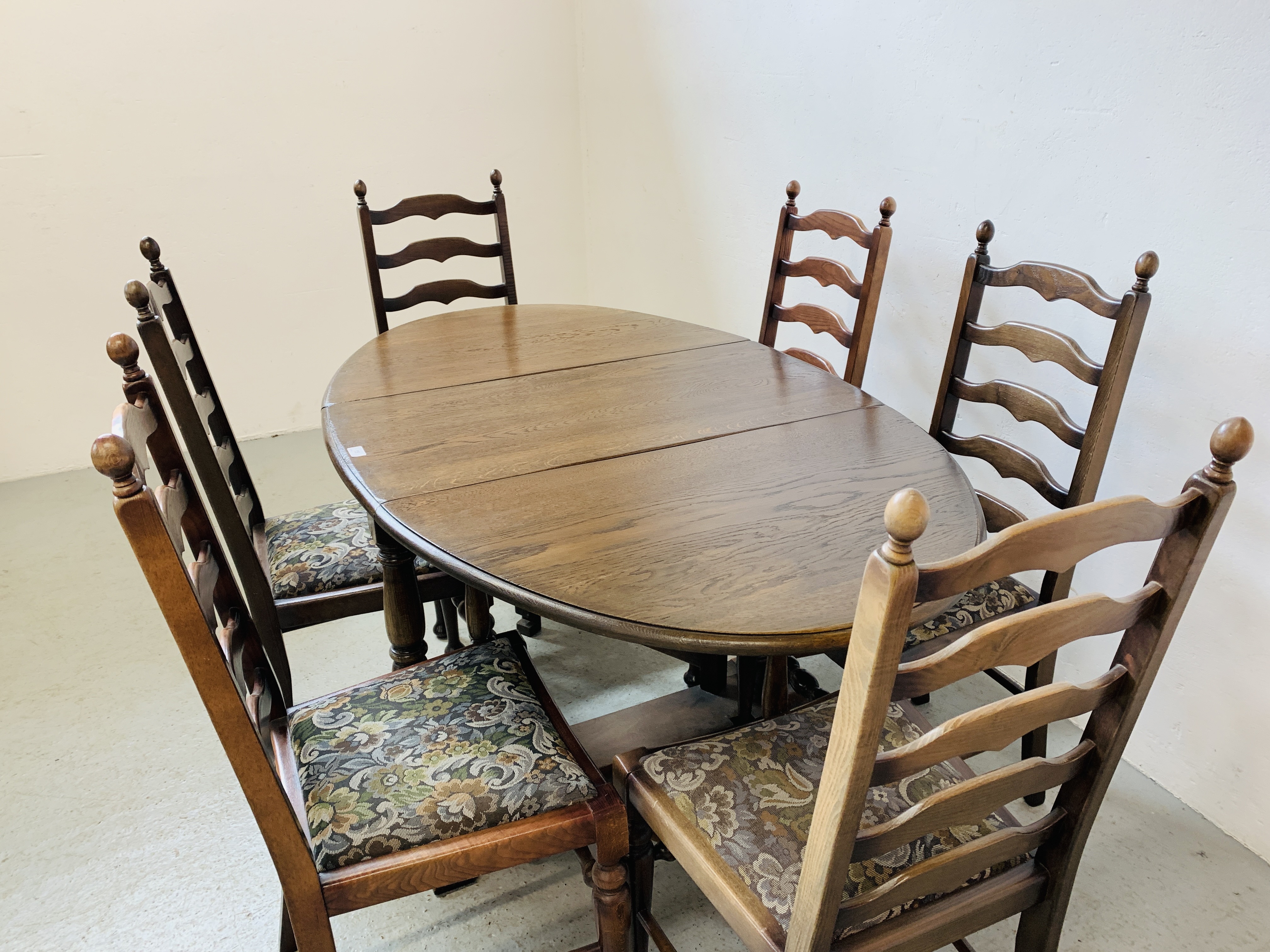 AN OVAL TOP OAK GATELEG DINING TABLE EXTENDED 152 X 91CM ALONG WITH A SET OF SIX LADDER BACK DINING - Image 3 of 12