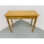 A SMALL LIGHT OAK TWO DRAWER SIDE TABLE 85CM X 34CM