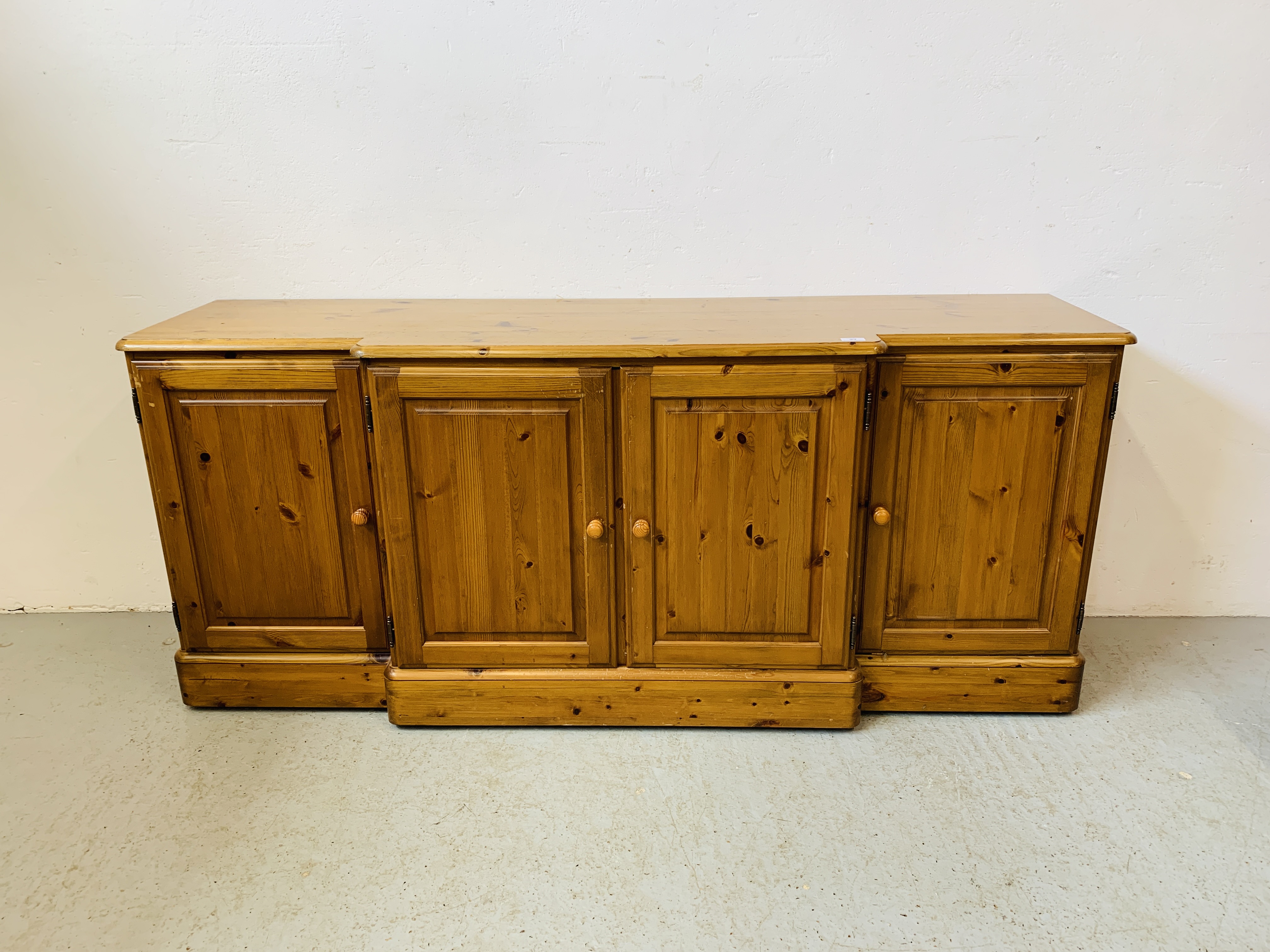 A DUCAL HONEY PINE BREAK FRONT FOUR DOOR DRESSER BASE - W 175 CM. D 46CM. H 75CM.