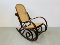 A BENTWOOD ROCKING CHAIR WITH RATTAN SEAT AND BACK