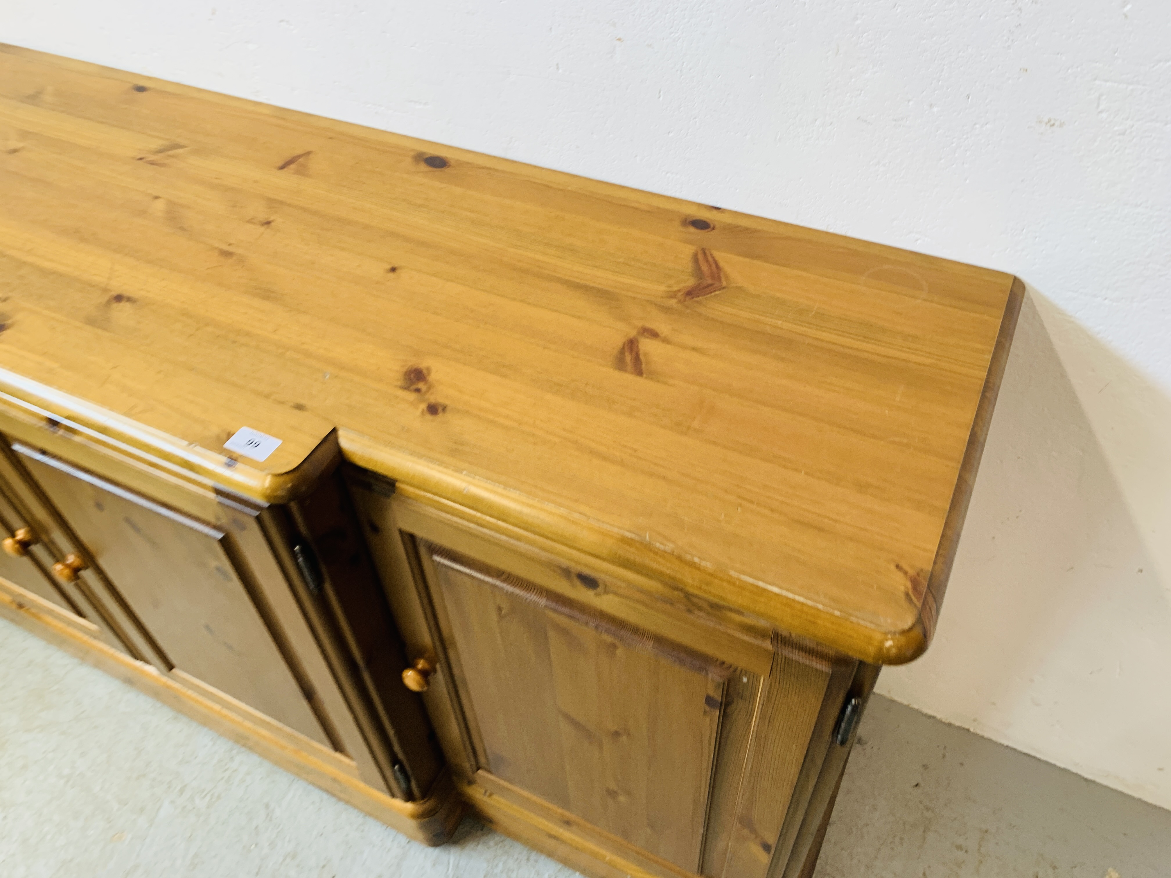 A DUCAL HONEY PINE BREAK FRONT FOUR DOOR DRESSER BASE - W 175 CM. D 46CM. H 75CM. - Image 8 of 9