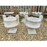A PAIR OF STONEWORK GARDEN PLANTERS ON STANDS WITH SCROLLED DETAIL HANDLES - HEIGHT 55 CM.