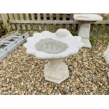 A SHELL DESIGN STONEWORK GARDEN BIRD BATH - HEIGHT 46 CM. DIAMETER 50 CM.