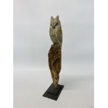 A CARVED MODEL OF AN OWL ON STUMP, THE OWL DECORATED AND HAVING GLASS EYES MONOGRAM CH TO BASE,