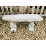 A STONEWORK GARDEN BENCH WITH LOG EFFECT SEAT SUPPORTED BY SQUIRRELS - LENGTH 100 CM.