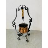 A WROUGHT METAL STAND WITH COPPERED FINISH COULDRON