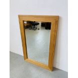 A MODERN LIGHT OAK RECTANGULAR WALL MIRROR WITH BEVELLED PLATE GLASS. W 61CM. H 91CM.