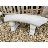 A STONEWORK GARDEN BENCH, CURVED SEAT SUPPORTED BY SCROLLED LEGS - LENGTH 110 CM.