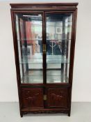 A REPRODUCTION ORIENTAL STYLE HARDWOOD DISPLAY CABINET WITH CABINET BASE,