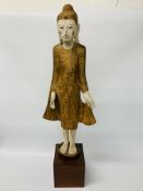 ORIENTAL CARVED HARDWOOD FIGURE OF A STANDING WOMAN GILDED WITH APPLIED JEWELLERY ON STAND - H 88.
