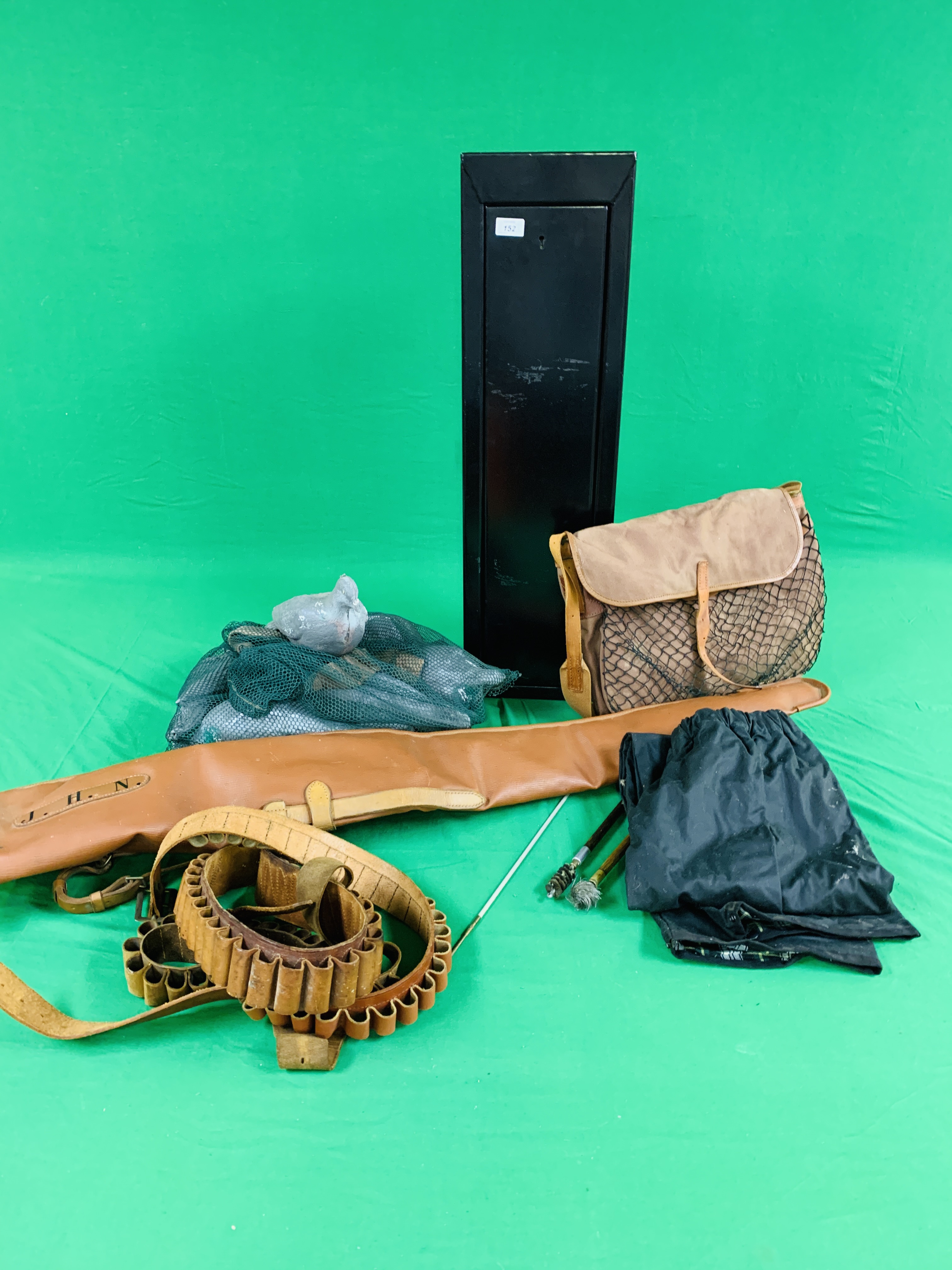 A SMALL STEEL "BREAK DOWN" GUN SECURITY CABINET, GAME BAG, THREE CARTRIDGE BELTS, A GUN SLEEVE,