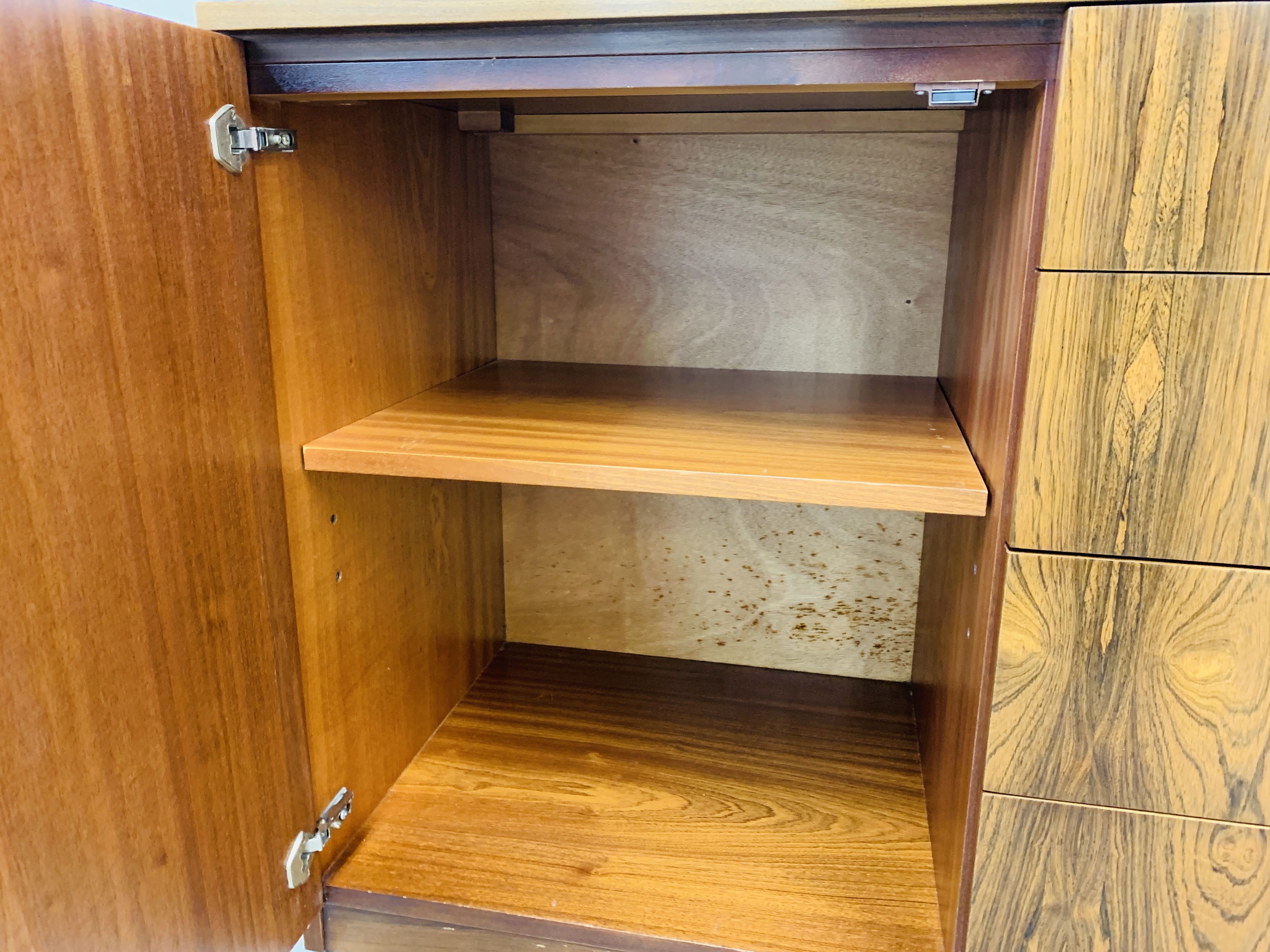 A C20TH BRAZILIAN ROSEWOOD RETRO SIDEBOARD HAVING FOUR CENTRAL DRAWERS FLANKED BY CUPBOARDS TO - Image 14 of 15