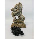 A VINTAGE CAST IRON RAMPANT LION DOOR STOP AND ORNATE CAST IRON DOOR KNOCKER