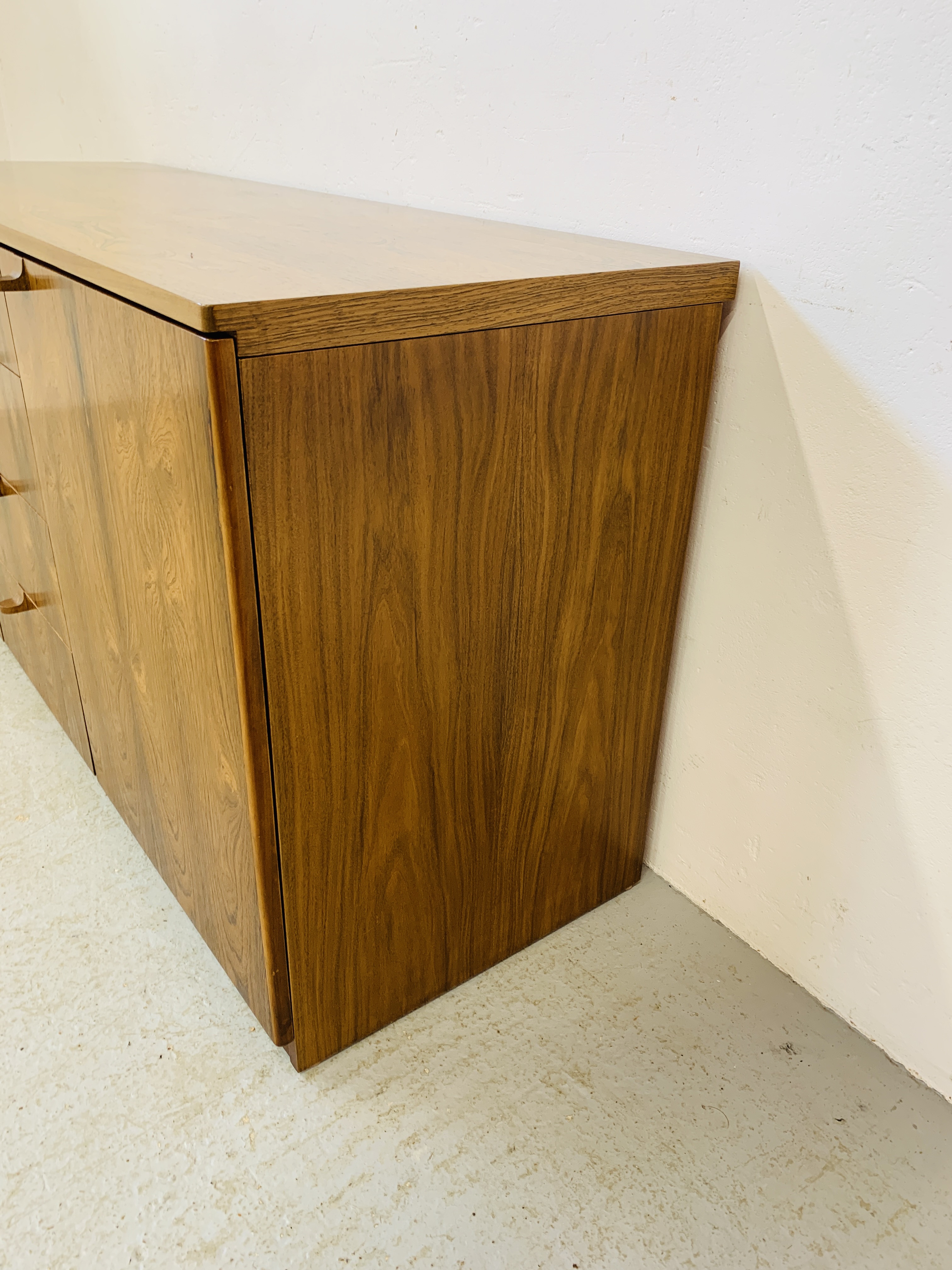 A C20TH BRAZILIAN ROSEWOOD RETRO SIDEBOARD HAVING FOUR CENTRAL DRAWERS FLANKED BY CUPBOARDS TO - Image 10 of 15