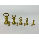 A GRADUATED SET OF NINE BRASS BELL WEIGHTS RANGING FROM 7 lB TO 1/2 OZ