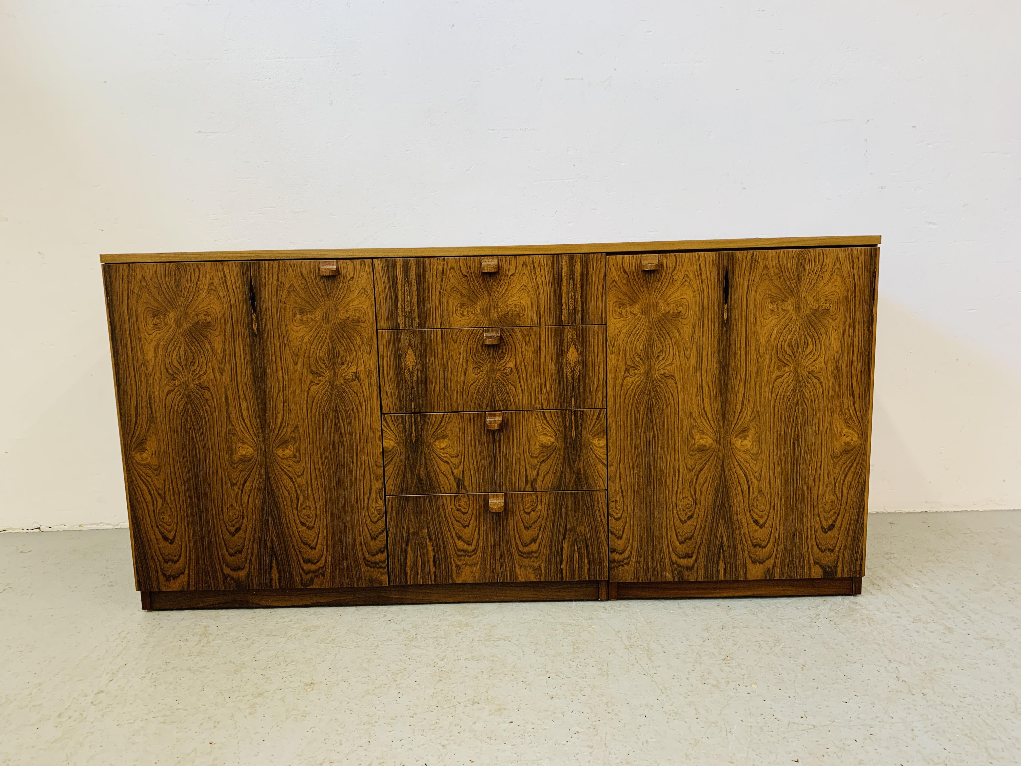 A C20TH BRAZILIAN ROSEWOOD RETRO SIDEBOARD HAVING FOUR CENTRAL DRAWERS FLANKED BY CUPBOARDS TO - Image 4 of 15