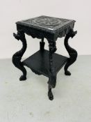 A HIGHLY DECORATIVE OAK TWO TIER STAND THE SUPPORTS DETAILED AS MYTHICAL CREATURES