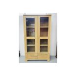 A MODERN QUALITY LIMED LIGHT OAK EFFECT FINISH TWO DOOR CABINET WITH GLAZED DOORS AND TWO DRAWERS