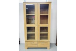 A MODERN QUALITY LIMED LIGHT OAK EFFECT FINISH TWO DOOR CABINET WITH GLAZED DOORS AND TWO DRAWERS