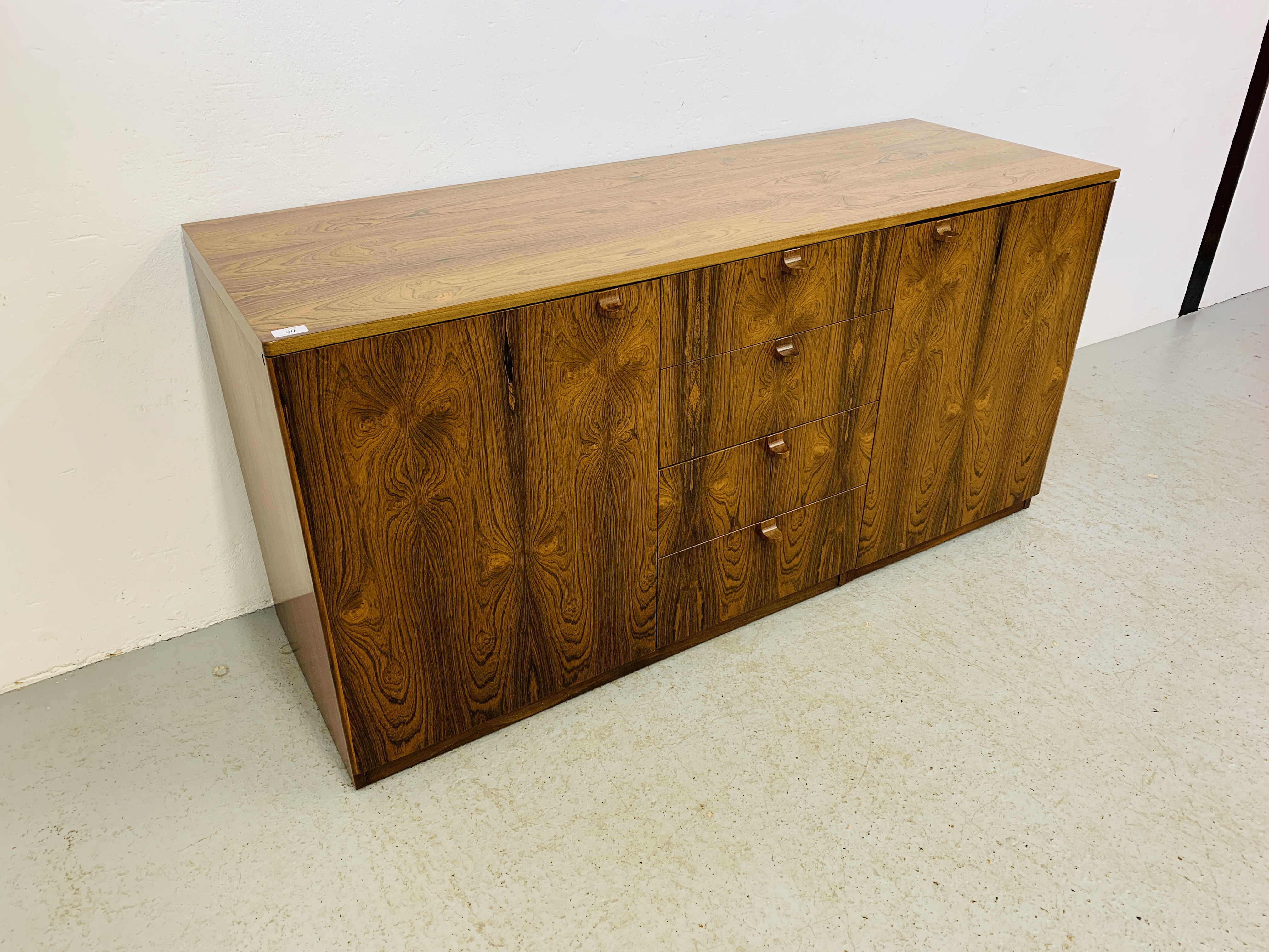 A C20TH BRAZILIAN ROSEWOOD RETRO SIDEBOARD HAVING FOUR CENTRAL DRAWERS FLANKED BY CUPBOARDS TO - Image 6 of 15