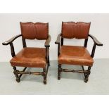 A PAIR OF MAHOGANY FRAMED ELBOW CHAIRS WITH TAN LEATHER SEATS AND BACKS