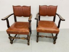 A PAIR OF MAHOGANY FRAMED ELBOW CHAIRS WITH TAN LEATHER SEATS AND BACKS