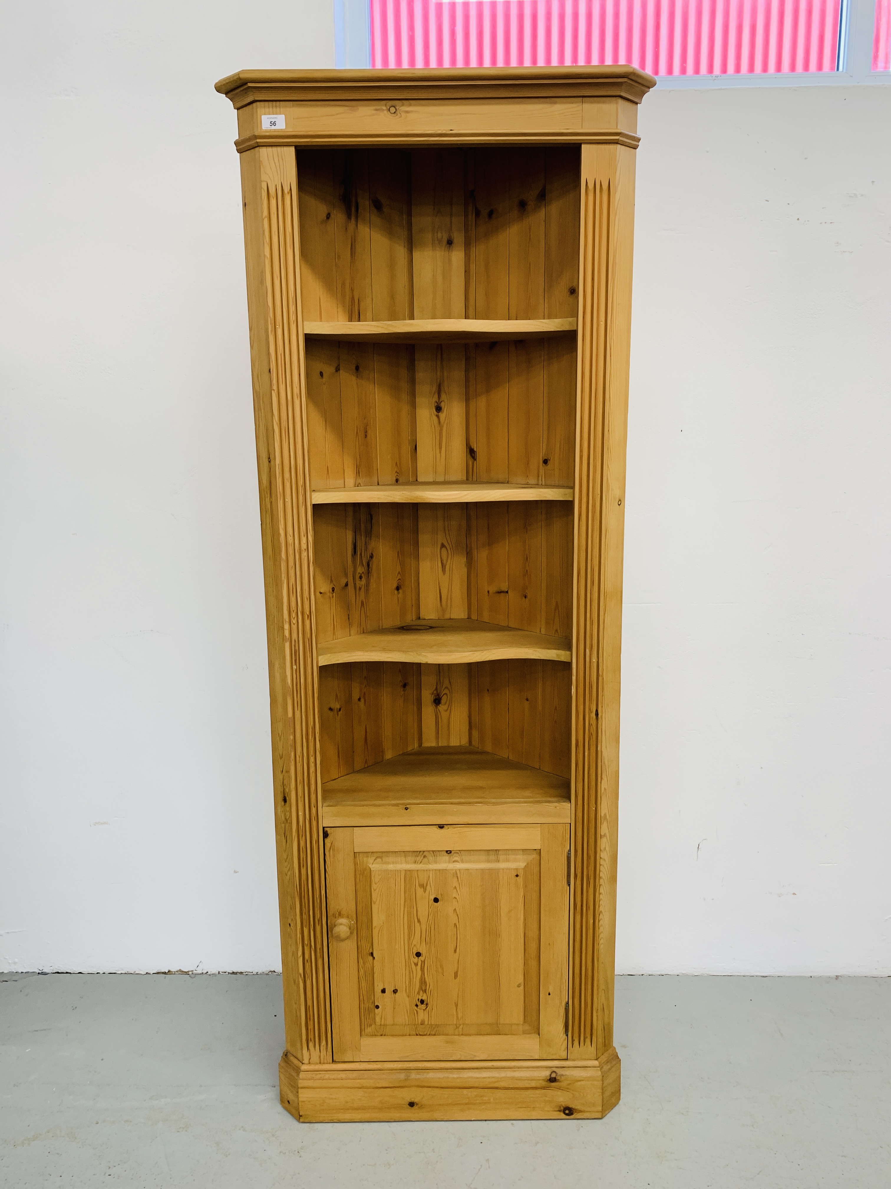 A WAXED PINE FULL HEIGHT CORNER SHELF UNIT WITH CABINET TO BASE H 198CM,