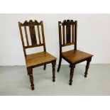 A PAIR OF OAK HARD SEAT HALL CHAIRS (BEARING LABEL TURNER-BARNES & WRIGHT - NORWICH)