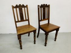 A PAIR OF OAK HARD SEAT HALL CHAIRS (BEARING LABEL TURNER-BARNES & WRIGHT - NORWICH)
