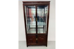 A REPRODUCTION ORIENTAL STYLE HARDWOOD DISPLAY CABINET WITH CABINET BASE,