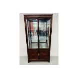 A REPRODUCTION ORIENTAL STYLE HARDWOOD DISPLAY CABINET WITH CABINET BASE,