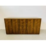 A C20TH BRAZILIAN ROSEWOOD RETRO SIDEBOARD HAVING FOUR CENTRAL DRAWERS FLANKED BY CUPBOARDS TO