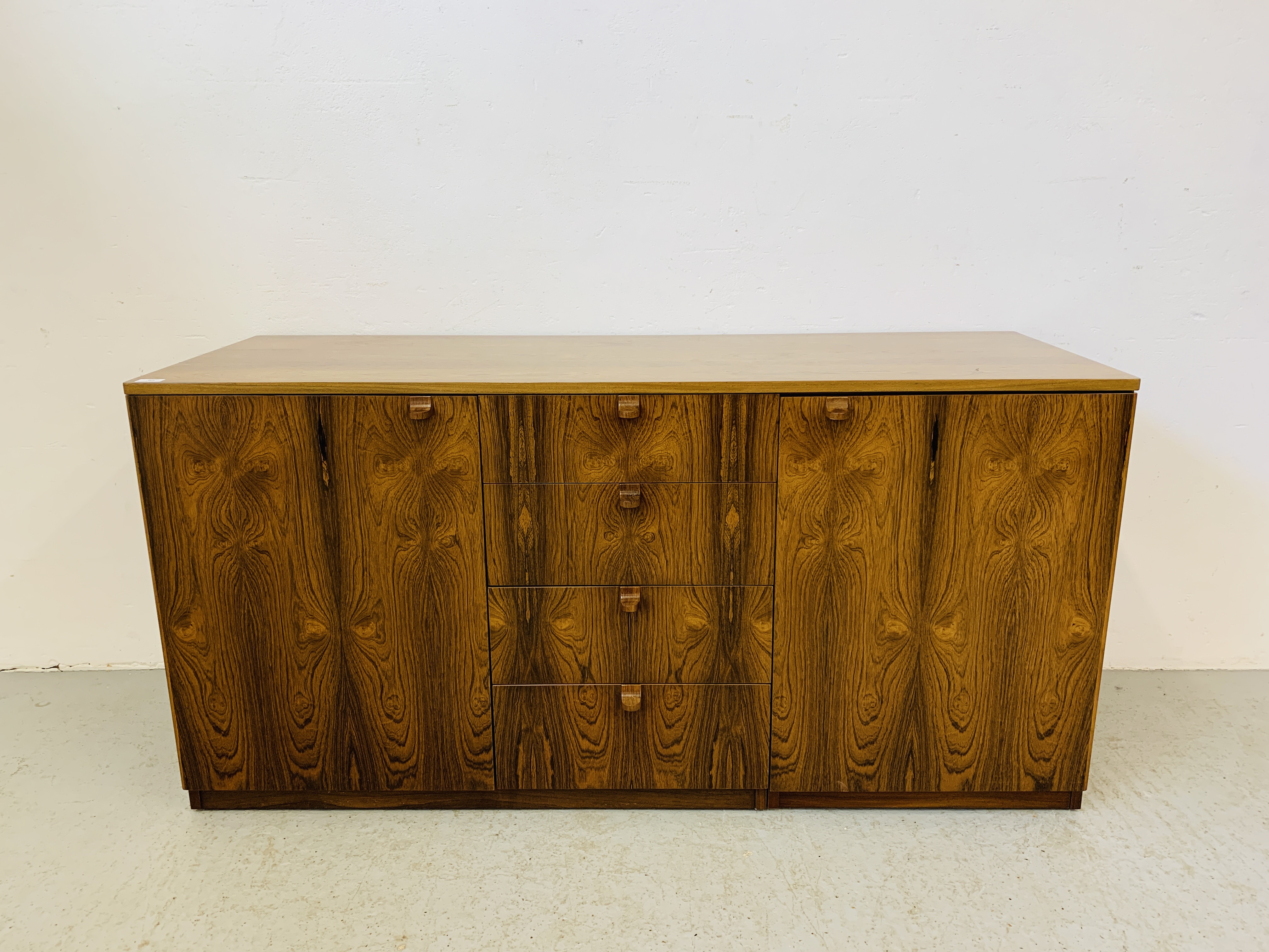 A C20TH BRAZILIAN ROSEWOOD RETRO SIDEBOARD HAVING FOUR CENTRAL DRAWERS FLANKED BY CUPBOARDS TO - Image 2 of 15