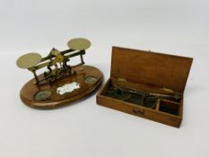 SET OF VINTAGE BRASS POSTAL SCALES WITH ENAMELED BADGE ALONG WITH A SET OF VINTAGE SCALES IN