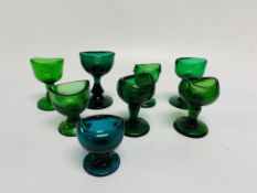 SIX GREEN GLASS EYE BATHS AND TWO TURQUO
