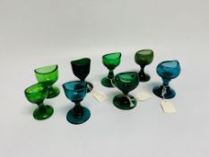SIX GREEN GLASS EYE BATHS AND TWO TURQUO