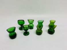 EIGHT GREEN GLASS EYE BATHS